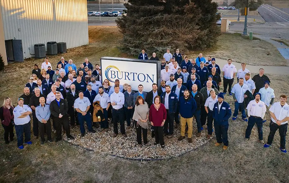 Burton's team standing around a Burton sign