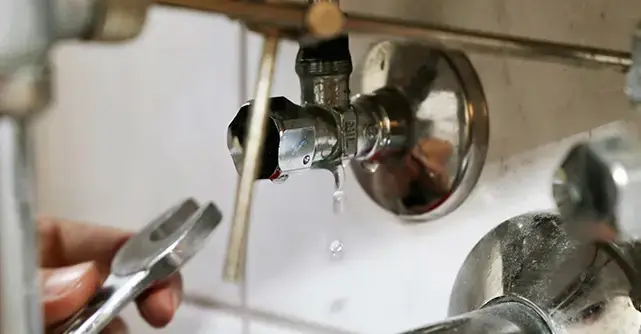 Plumbing repair work on a leaking pipe