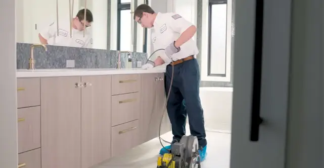 Burton plumber working on a drain clearing