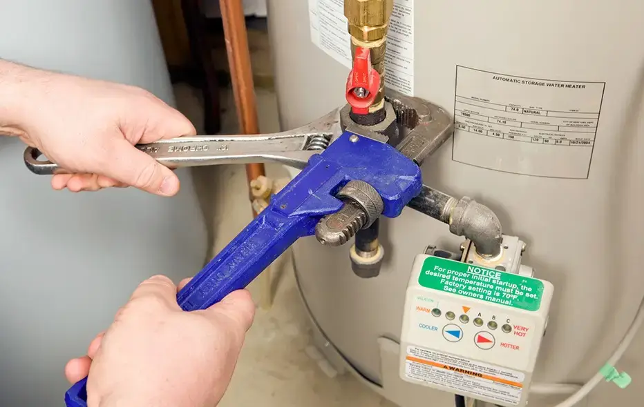 Plumber working on installing a water line for a water heater